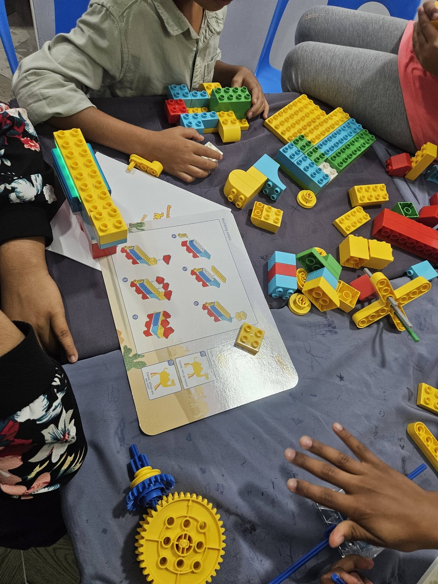 Children building with robotics parts during a hands-on STEM session