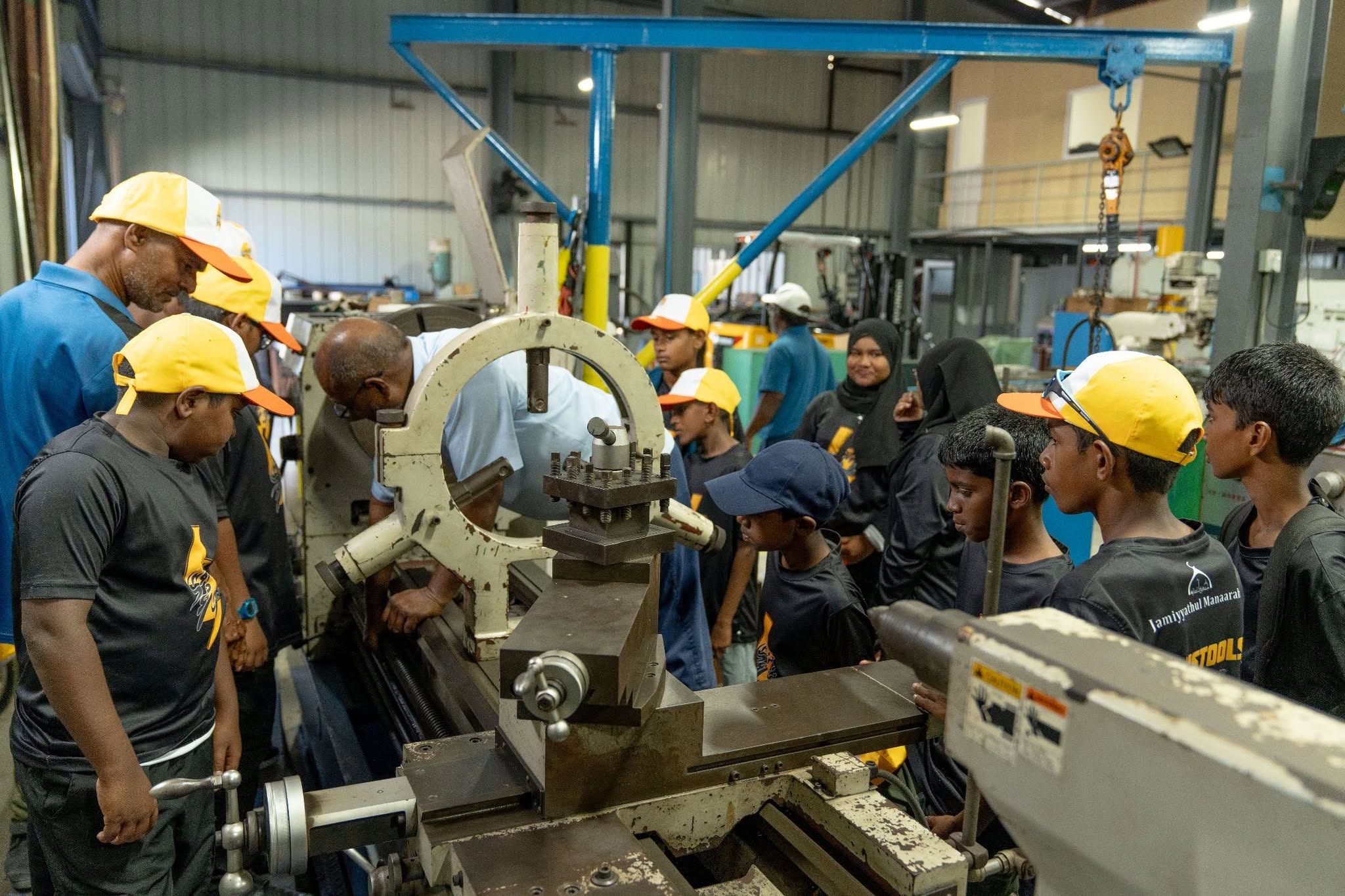 Students observing a machine shop demonstration during a field visit